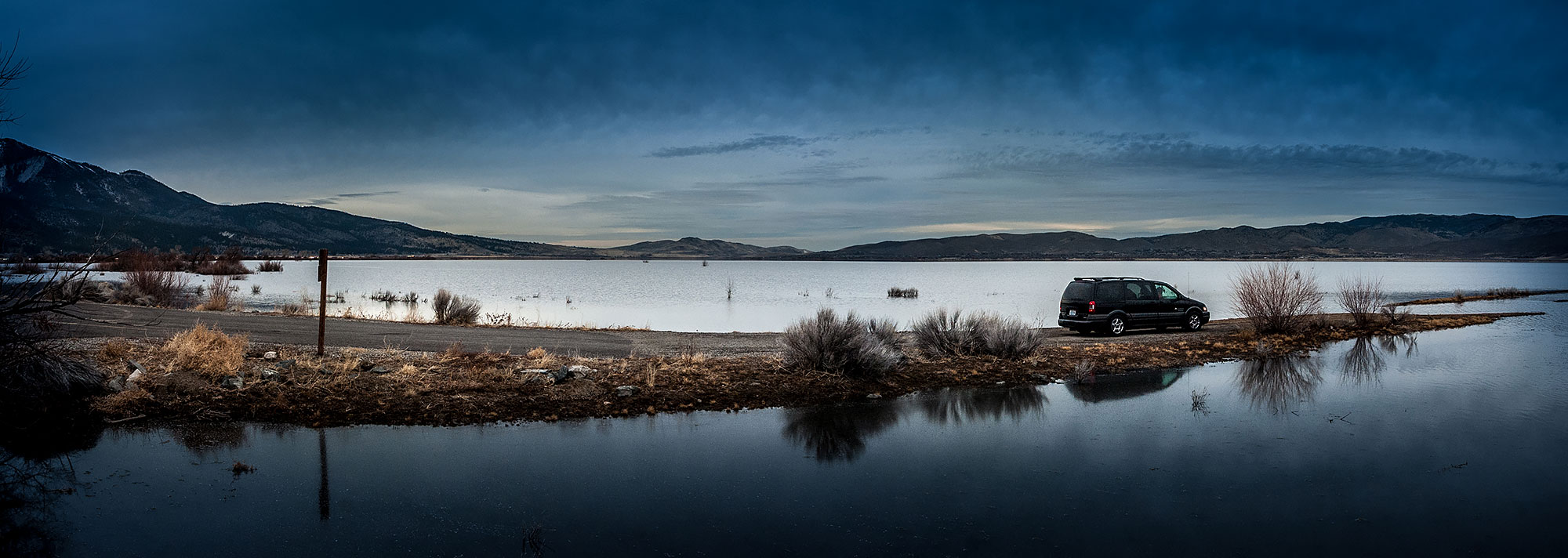 Panoramic view of a 2003 AWD Pontiac Montana Thunder parked on a stretch of land leading into Columbia river, on the road trip from California to Alberta.